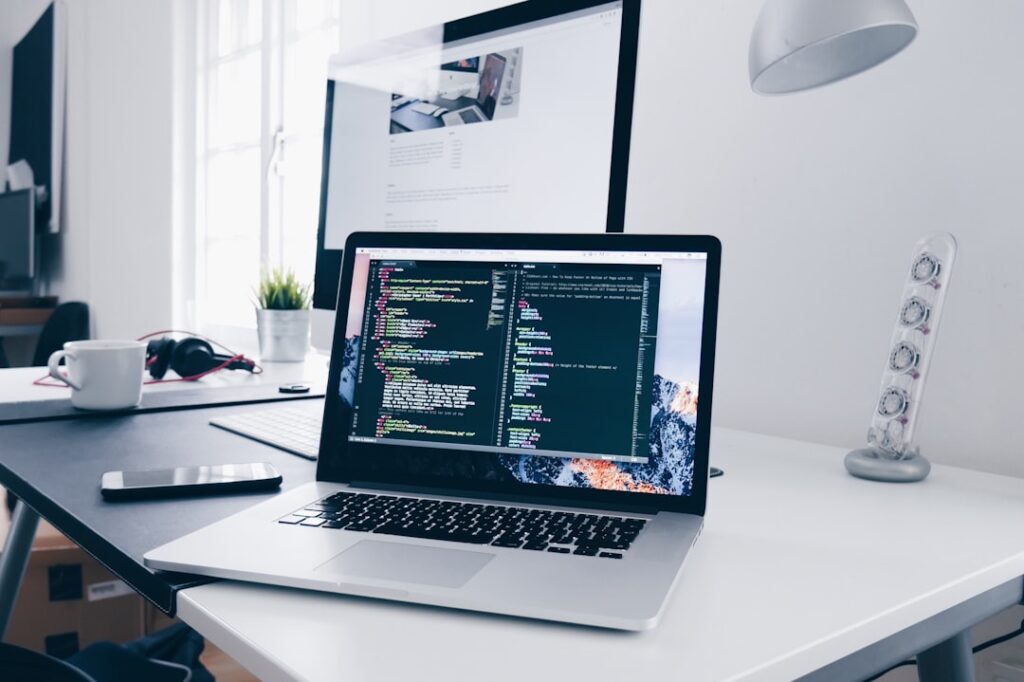 quant research — A MacBook with lines of code on its screen on a busy desk