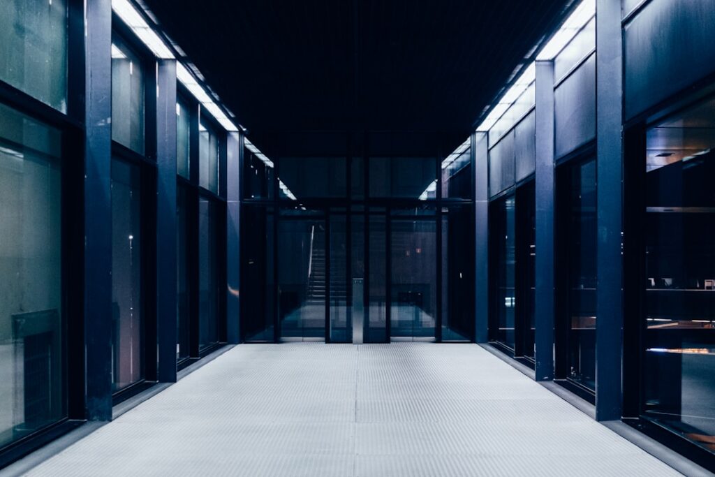 self-hosted llm — a long hallway with glass doors leading to another room